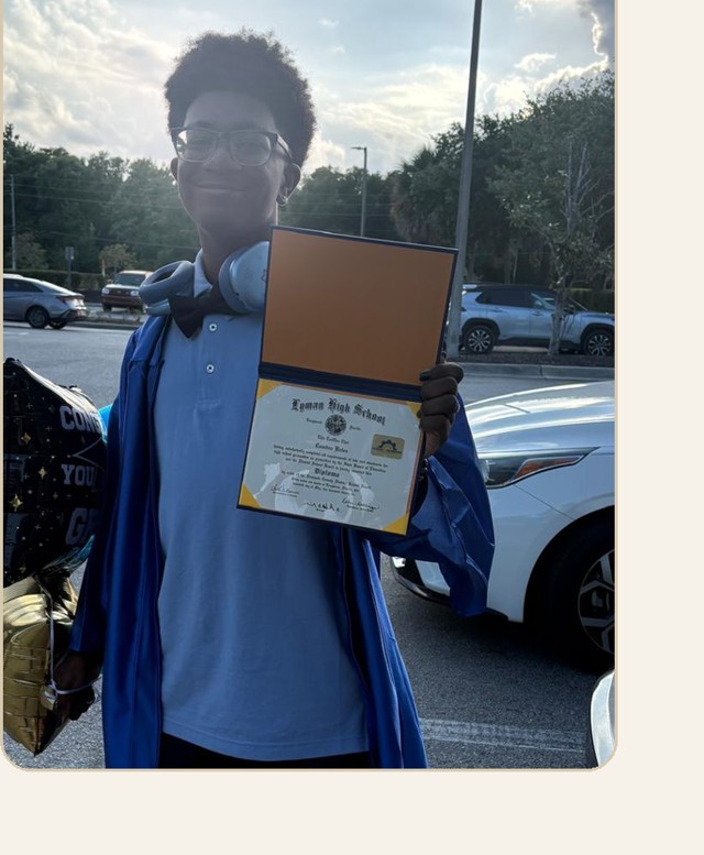 Camden Bates on graduation day holding his diploma